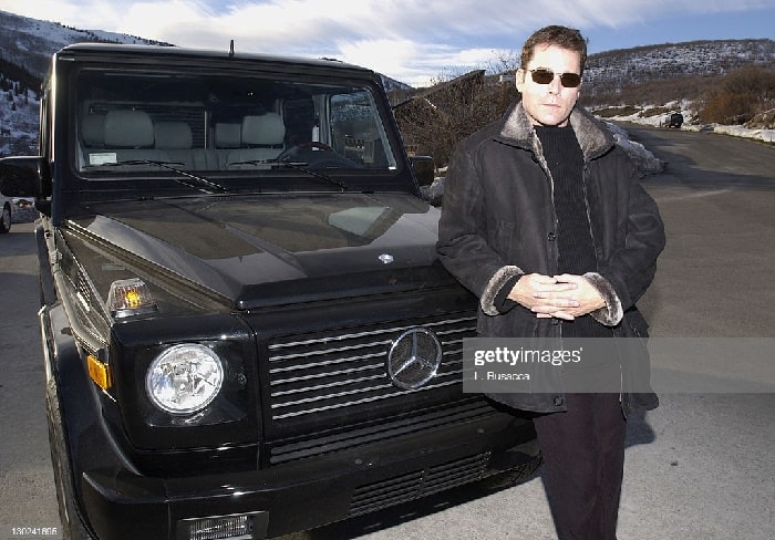 Ray Liotta posing in front of his black Mercedez BEnx-G500
